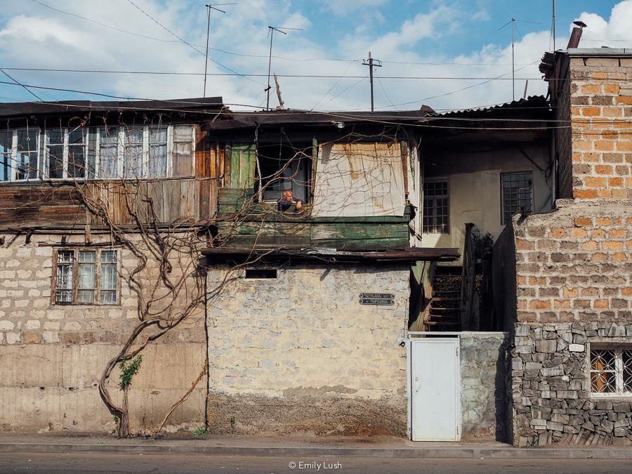 A man looks out the window of his house in Kond district, Yerevan.