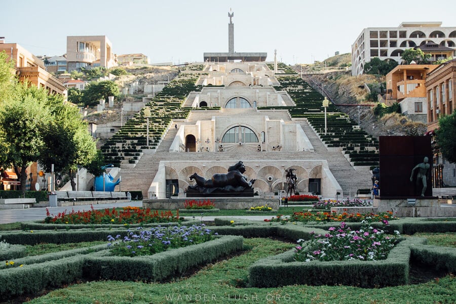 A large stone staircase with a garden at the bottom.