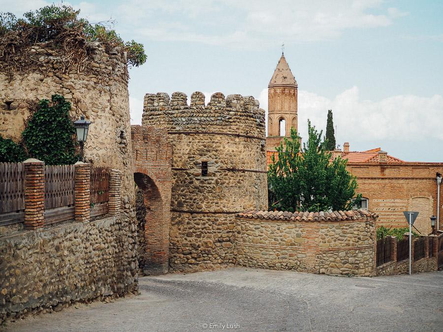 Stone walls and a church tower in Sighnaghi, Georgia.