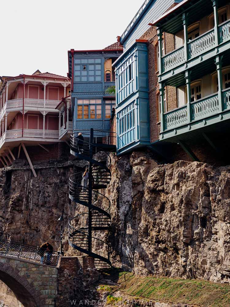 Old houses on the cliff above the waterfall in Tbilisi.