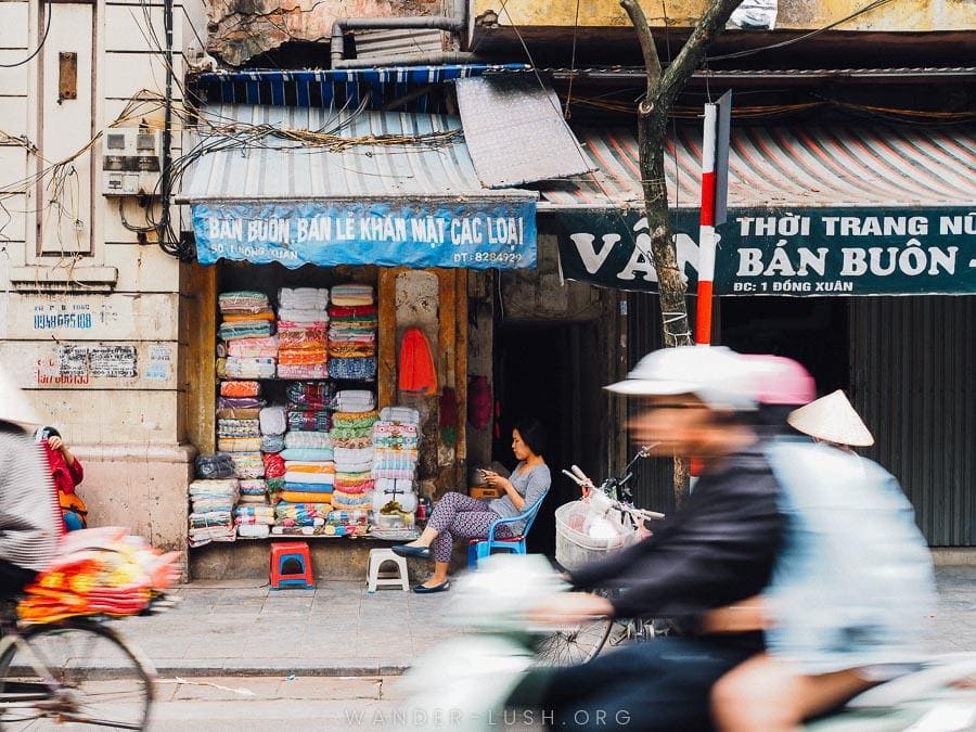 Bikes speed past shops in the Old Quarter, Hanoi.