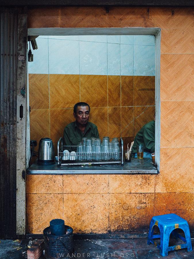 A man sits inside a small restaurant in Hanoi Old Quarter.