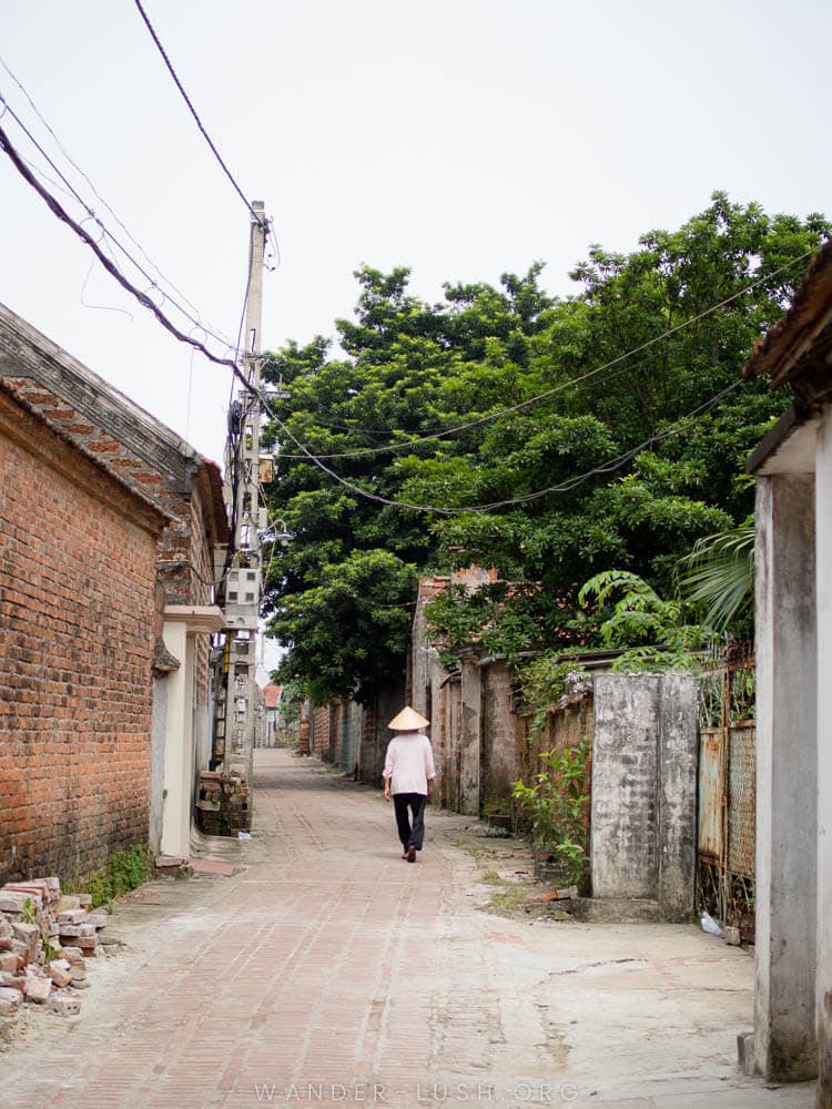 A man walks down the street in Duong Lam Ancient Village near Hanoi.