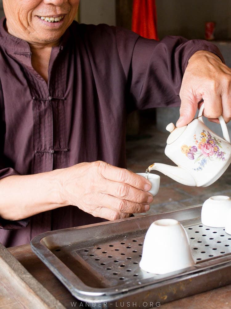 A man pours green tea from a pot at Duong Lam Ancient Village near Hanoi.