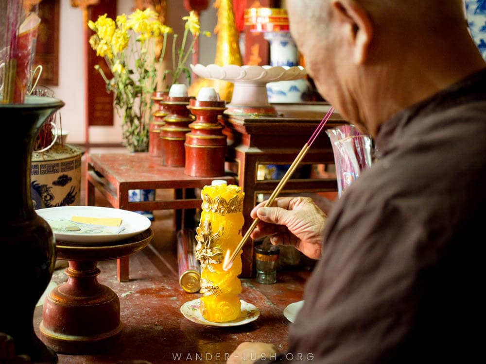 A man lights Vietnamese incense at Duong Lam Ancient Village near Hanoi.
