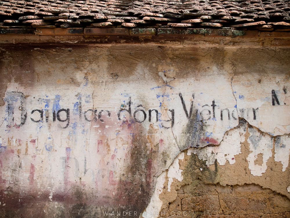 An old wall with graffiti in Duong Lam Ancient Village near Hanoi, Vietnam.