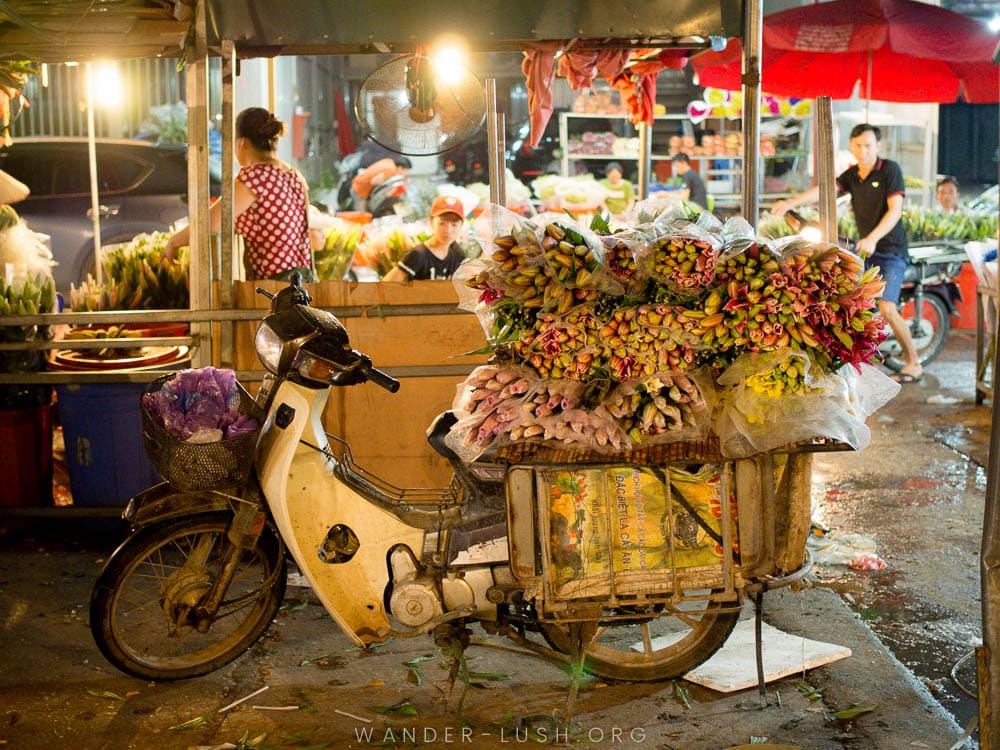 A motorcycle loaded up with wrapped bunches of tulips and lotus flowers at the Quang Ba market in Hanoi.
