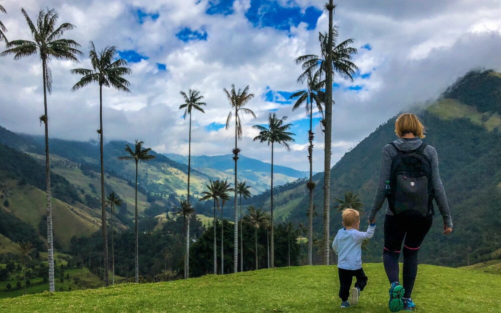 A mother and child walk through Cocora Valley in Colombia.