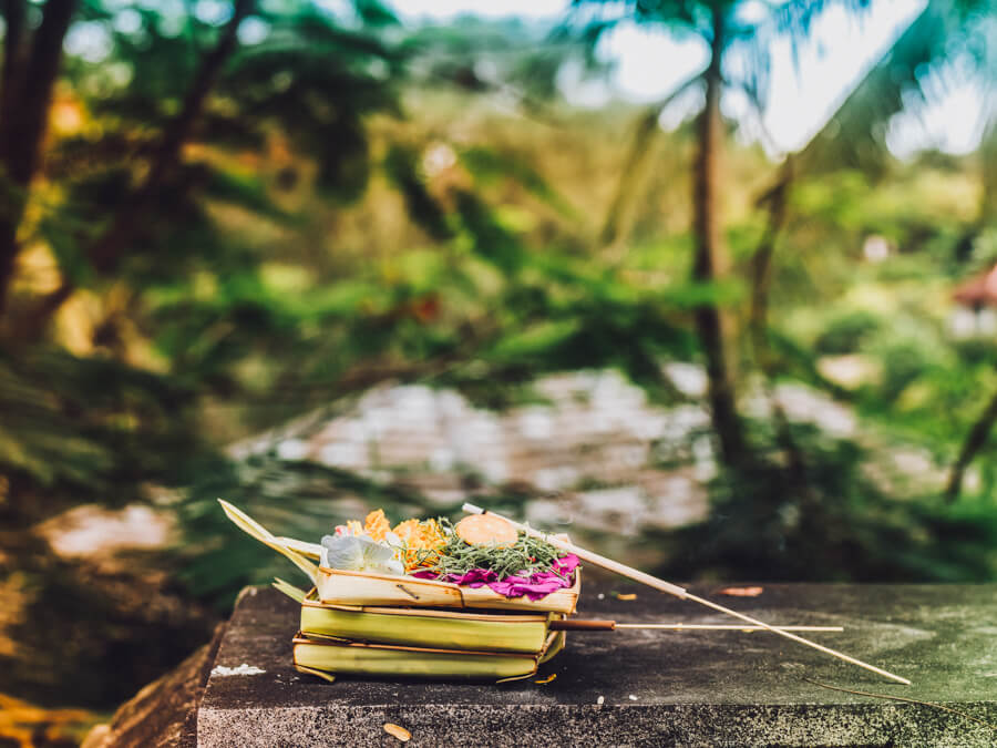 A traditional offering sits on a wooden table in Bali, Indonesia.