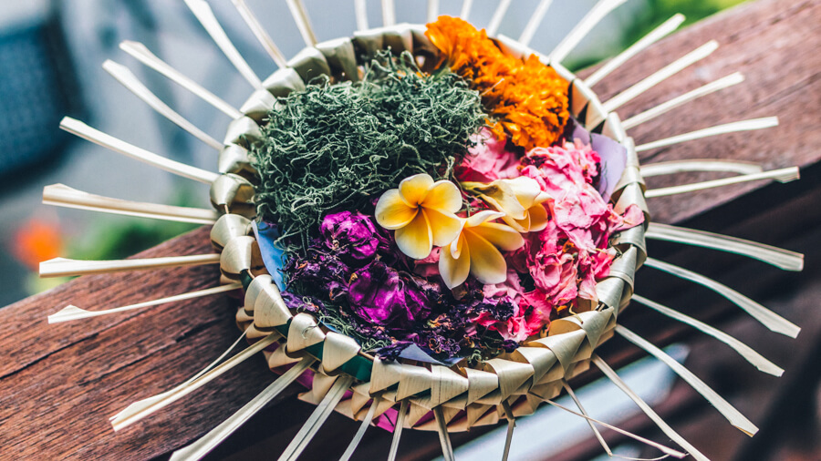 A woven basket filled with colourful flowers in Bali, Indonesia.