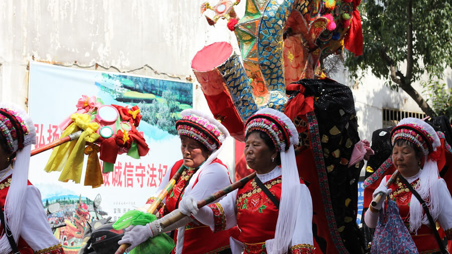 Woman parade down the street in China.