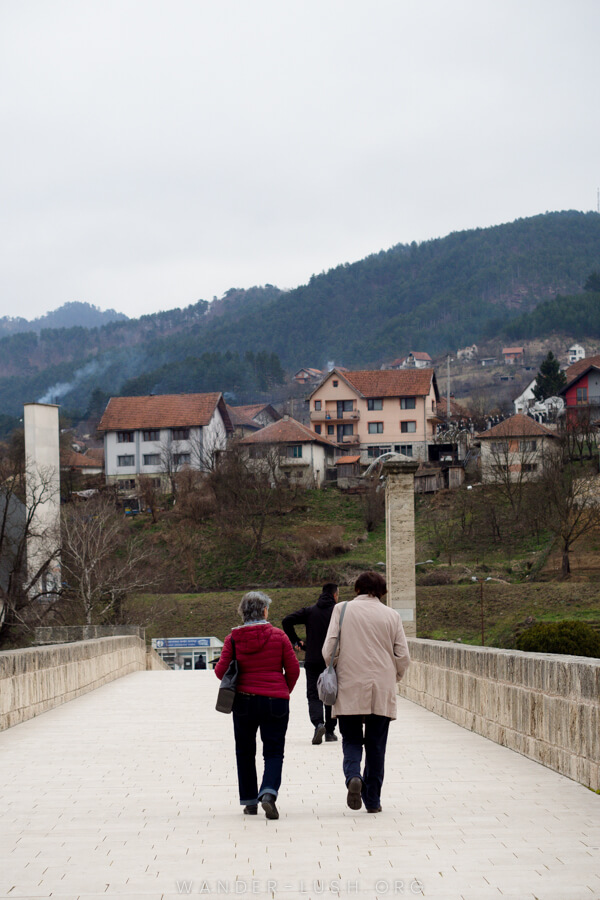Two women walk across The Mehmed Paša Sokolović Bridge in Visegrad, Bosnia.