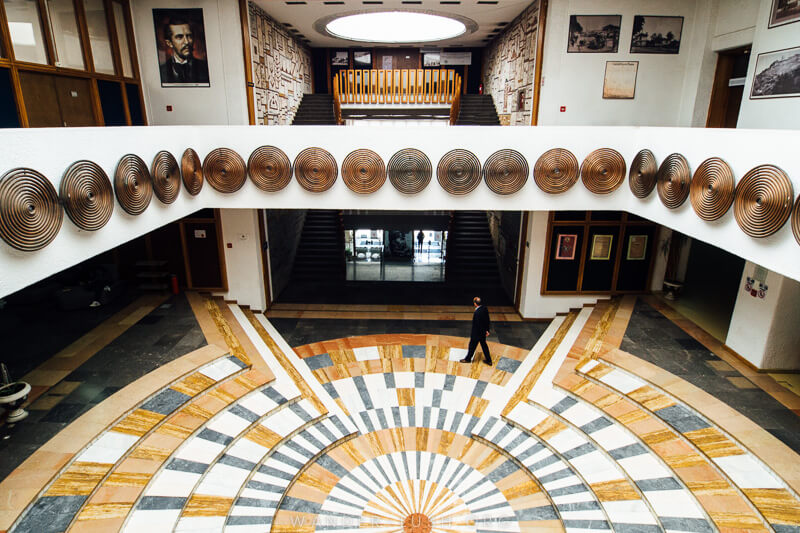 A large floor mosaic inside the National Library of Kosovo.