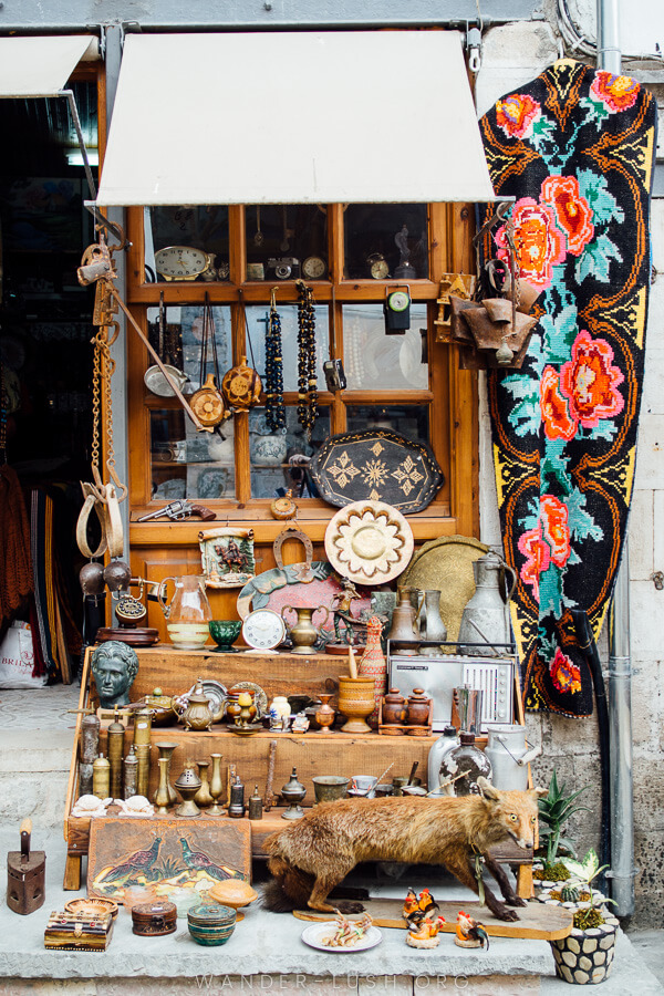 A shop sells antique carpets and plates in Gjirokaster, Albania.