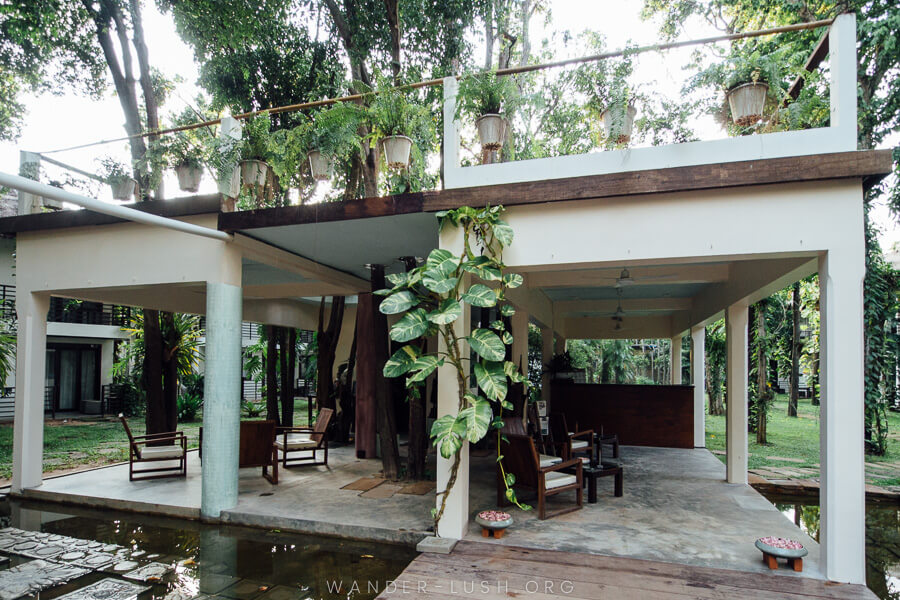 A modern white building with open walls and seating inside.