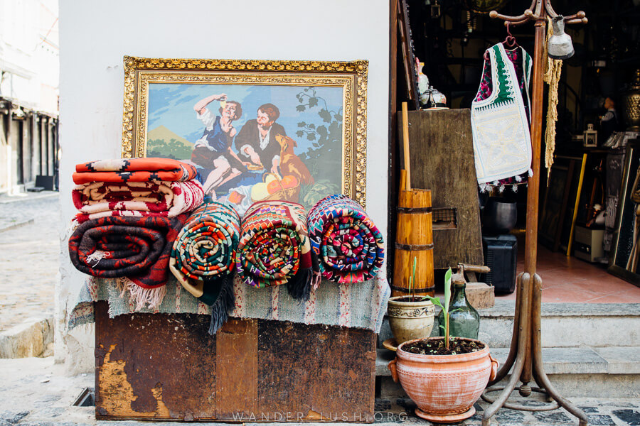 An antique shop in Korca, with rolled carpets out the front.