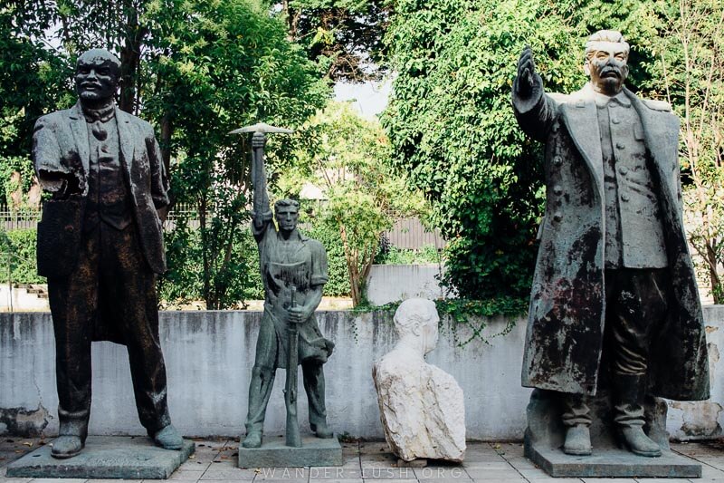 Four damaged Communist statues in a garden behind the National History Museum in Tirana, Albania.