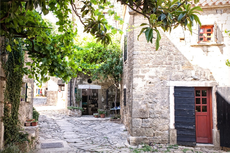 Stone walls and coloured doors in a small town, one of the most beautiful places in Istria.