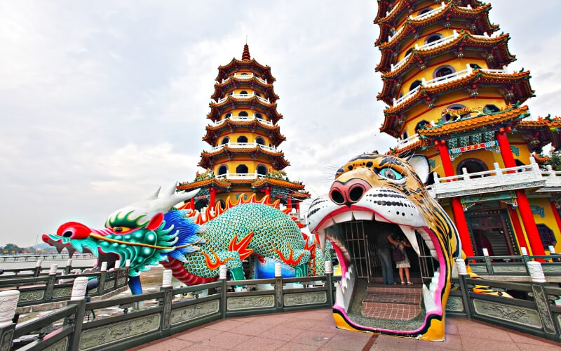 Temples and two statues resembling a dragon and tiger in Kaohsiung, Taiwan.