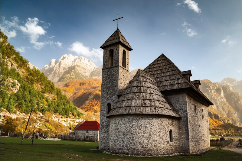 A round stone church in Theth, Albania.