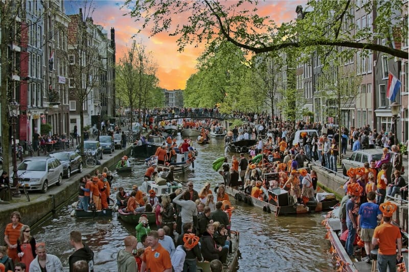 People celebrate Kingsday, a Dutch tradition, on the canals of Amsterdam.
