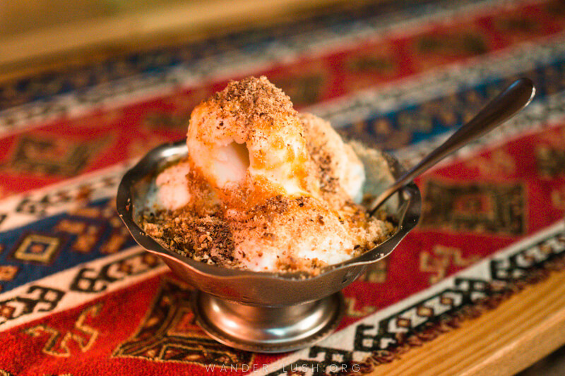 A scoop of ice cream with tangerine jam and crushed nuts at an Abkhazian restaurant in Tbilisi, Georgia.