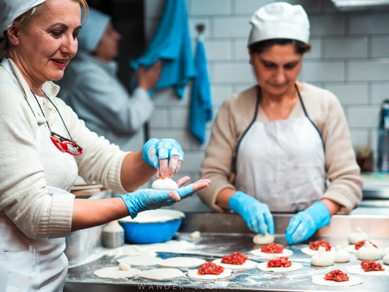 Two women prepare food in a kitchen in Tbilisi.