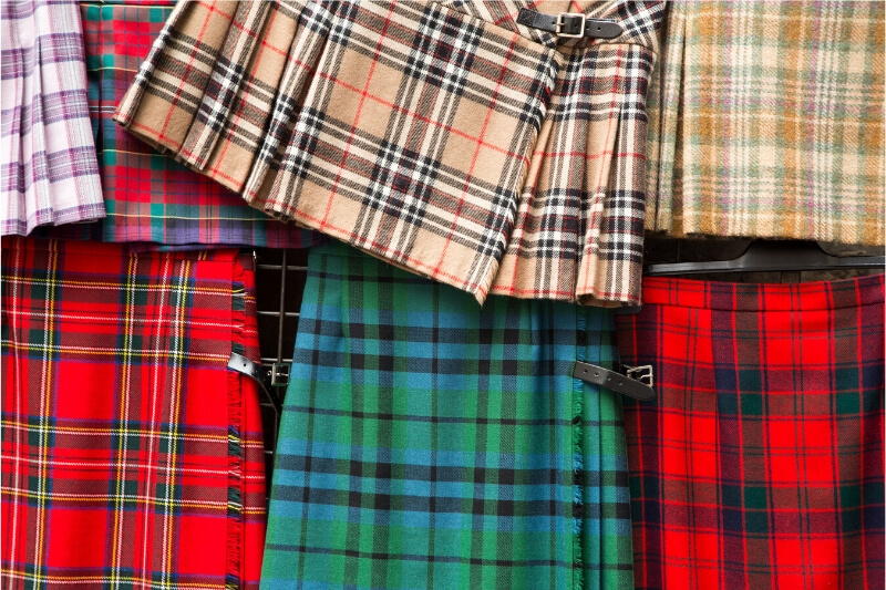 A flatlay of colourful Scottish kilts.