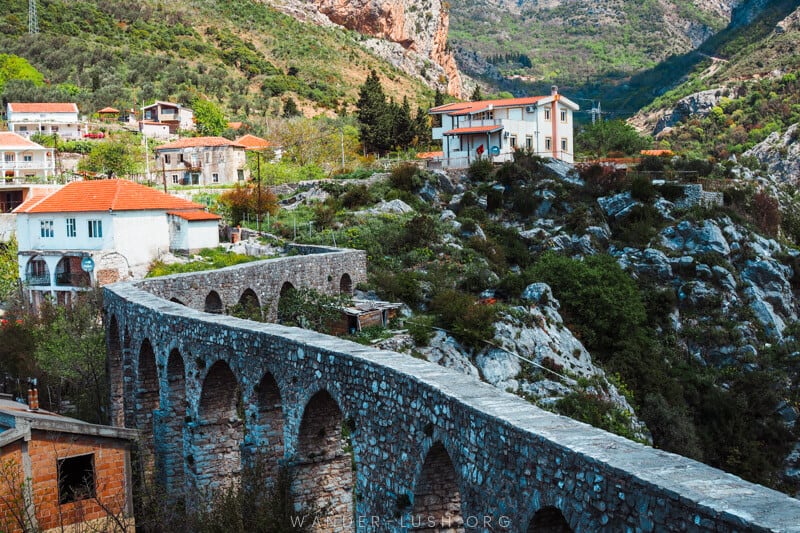 A stone aqueduct winds its way through the hilly town of Stari Bar in Montenegro.