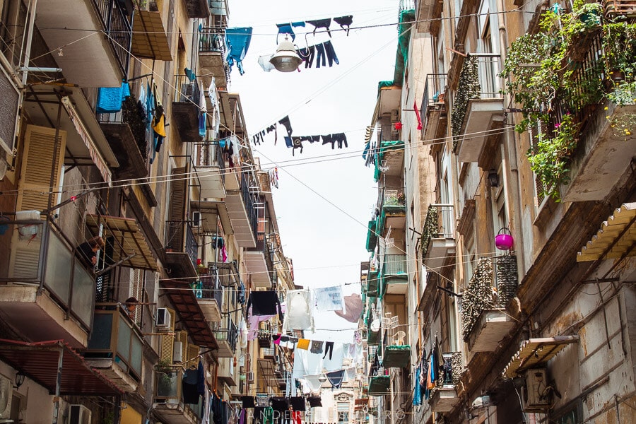 Streets of Naples, buildings with washing lines strung between them.