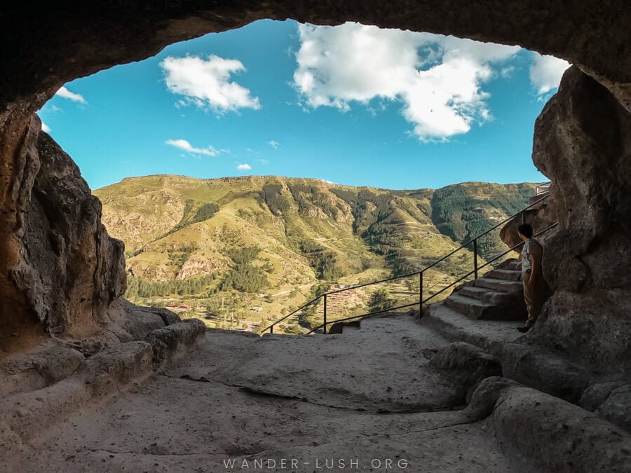 Blue skies and green hills viewed from inside a cave in Vardzia, Georgia.