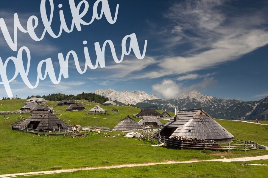 Mountain huts set on a green pasture in Velika Panina, Slovenia.