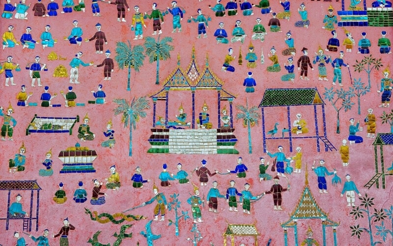 Tiny glass mosaics decorate a pink wall at Wat Xiengthong temple in Luang Prabang.