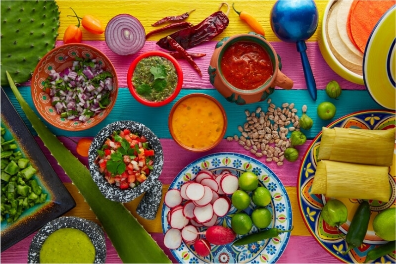 A spread of brightly coloured Mexican food.