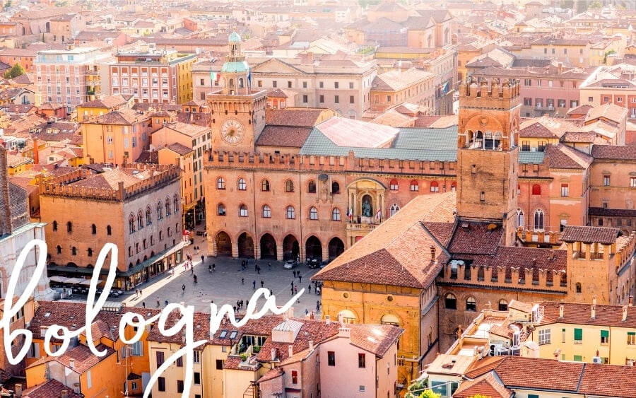 The main square in Bologna, Italy with its red-roofed houses and towers.