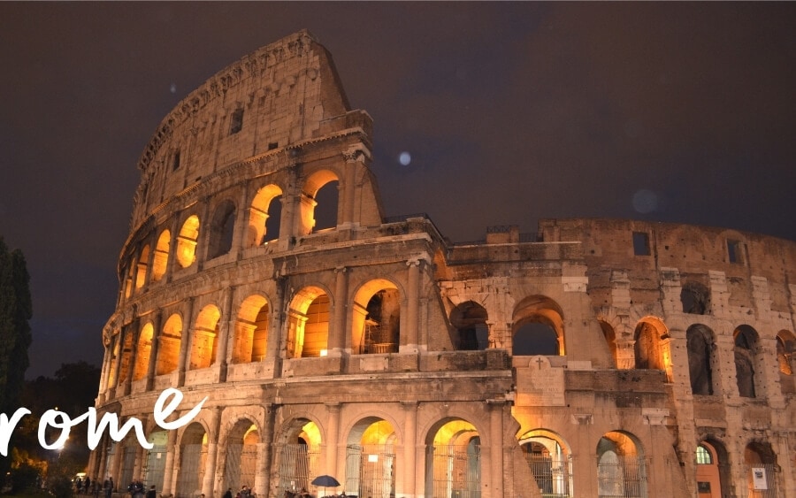 Rome's colosseum lit up at night.