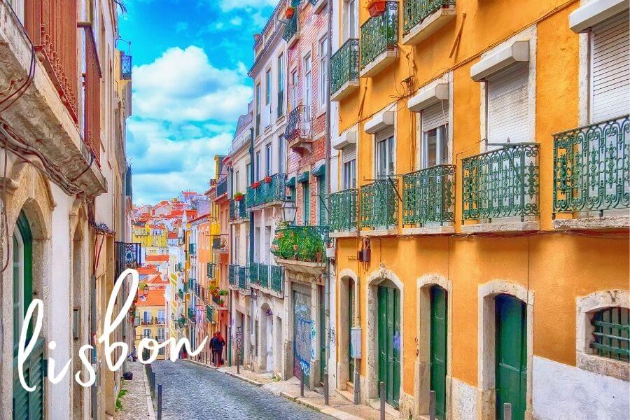 Coloured apartment blocks line a narrow street in the city of Lisbon.