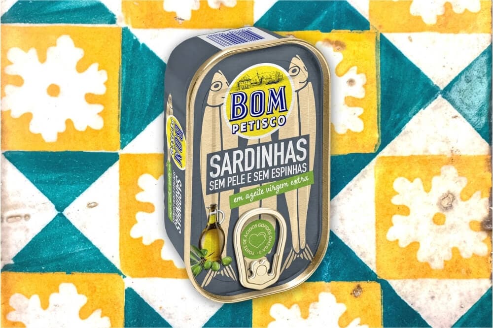 A colourful can of Portuguese sardines against a backdrop of traditional tiles.