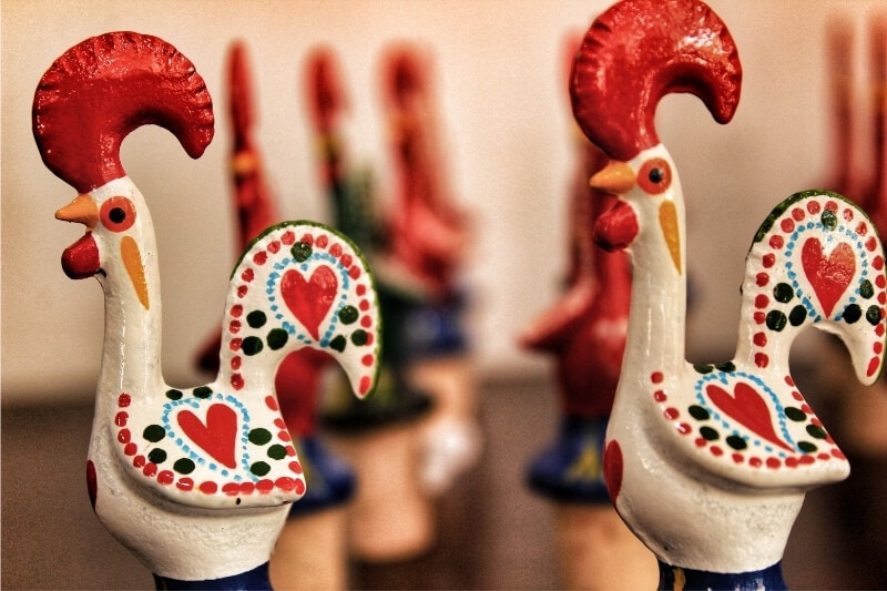 Miniature statues of the Barcelos Rooster, a popular symbol in Portuguese handicrafts. 