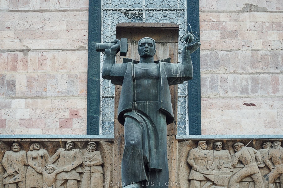 A Soviet-style statue made from grey and pink stone in the city of Vanadzor, Armenia.