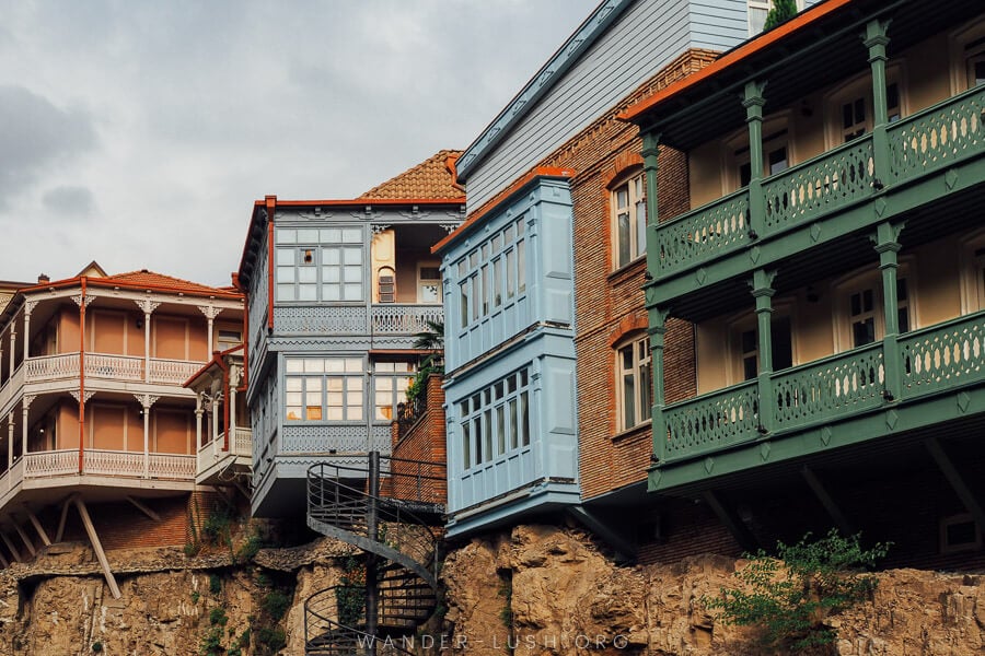 Old balconied houses in Tbilisi atop a cliff.