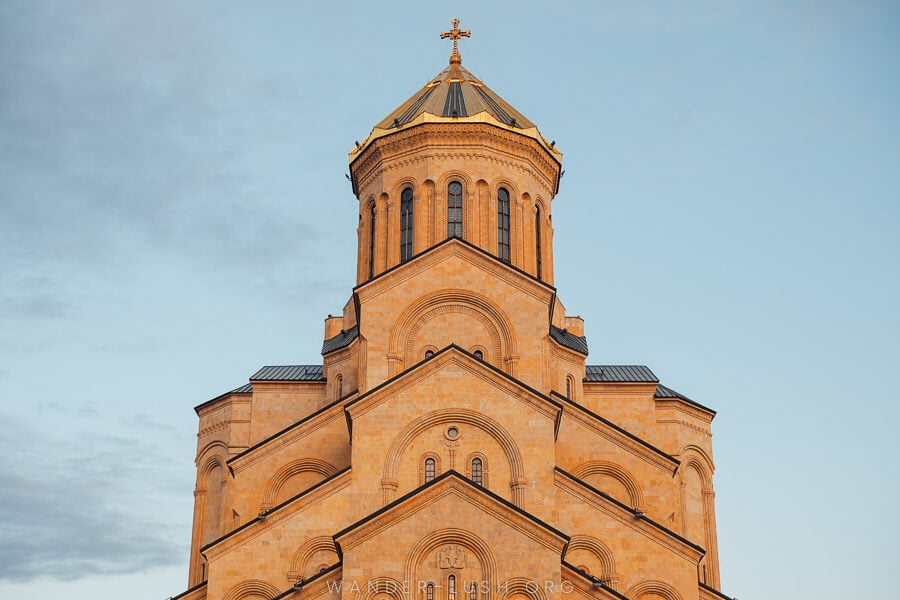 A close-up of Sameba Cathedral in Tbilisi at sunset.