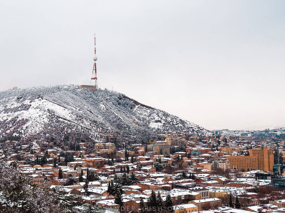 Tbilisi, Georgia under a blanket of snow, with Mtatsminda and the Tbilisi TV Tower in the distance.