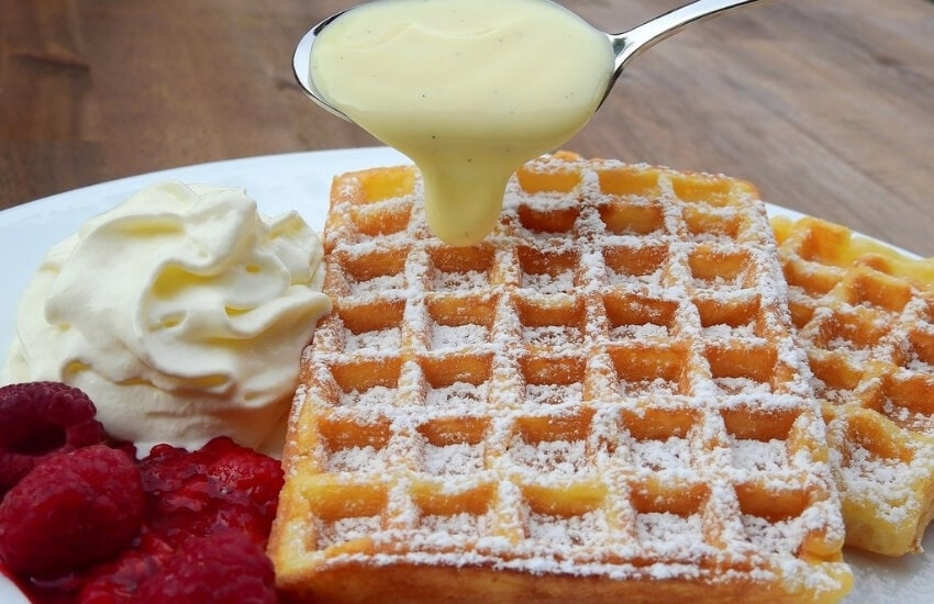 Belgian waffles served with cream and berries.