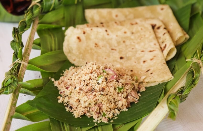 Tuna salad and thin roti bread served on banana leaves.