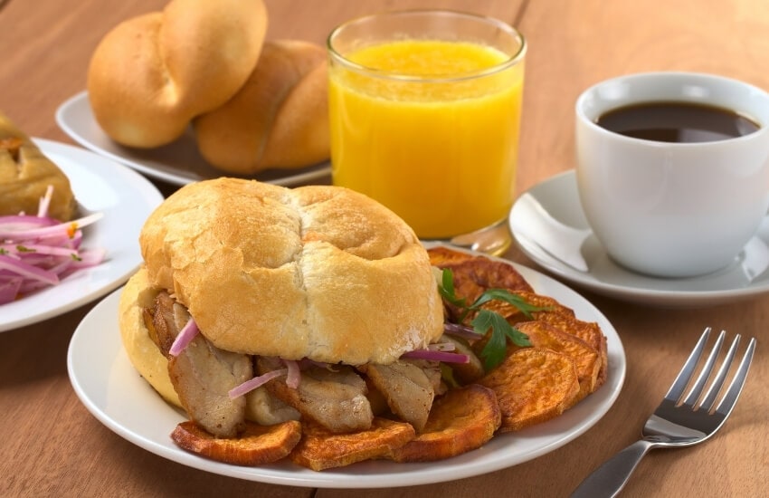 Pork served in a bun for breakfast in Peru.
