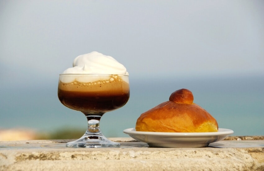 A glass of Sicilian granita and a brioche.