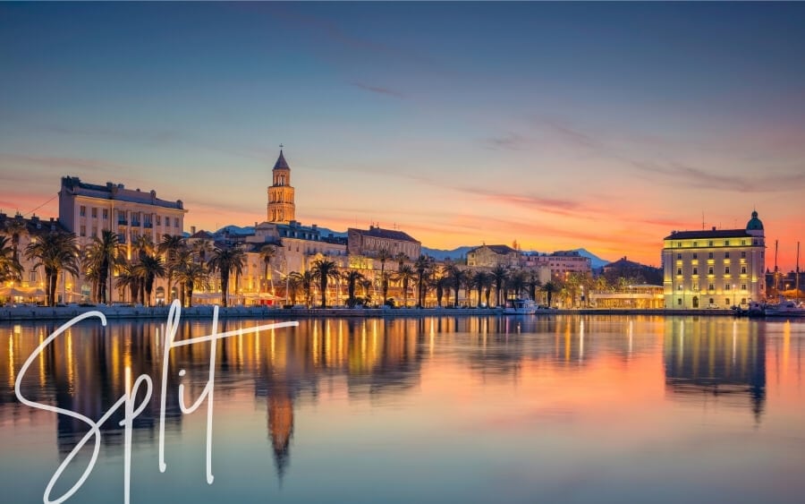 The old town of Split, Croatia at night, with the city lights mirrored on the bay.