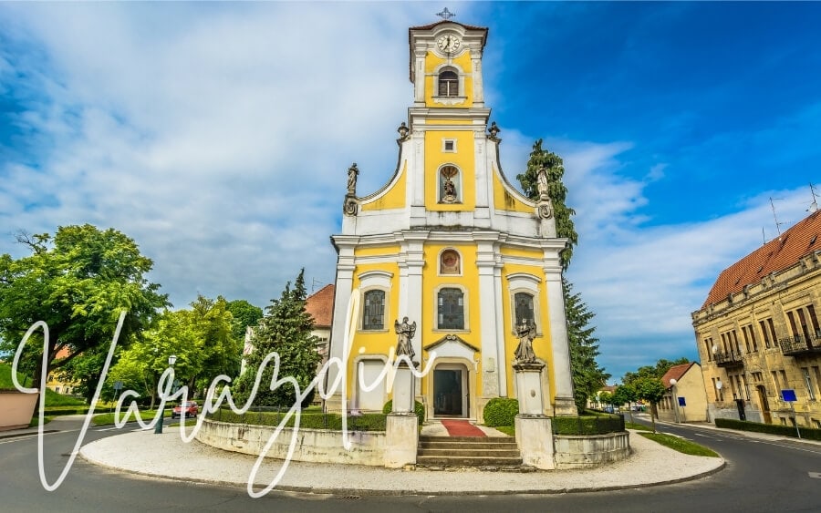 A yellow-coloured church stands in a square in Varazdin, Croatia.