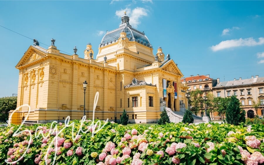 A grand lemon-coloured building in Zagreb, a must-visit city in Croatia.